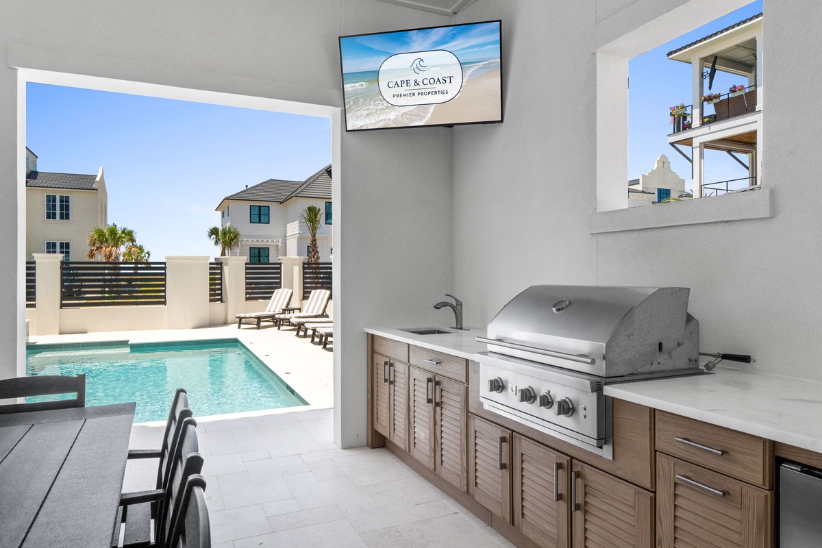 Your private poolside grilling station awaits, where stainless steel meets coastal elegance. Fire up the grill while the pool sparkles just steps away.