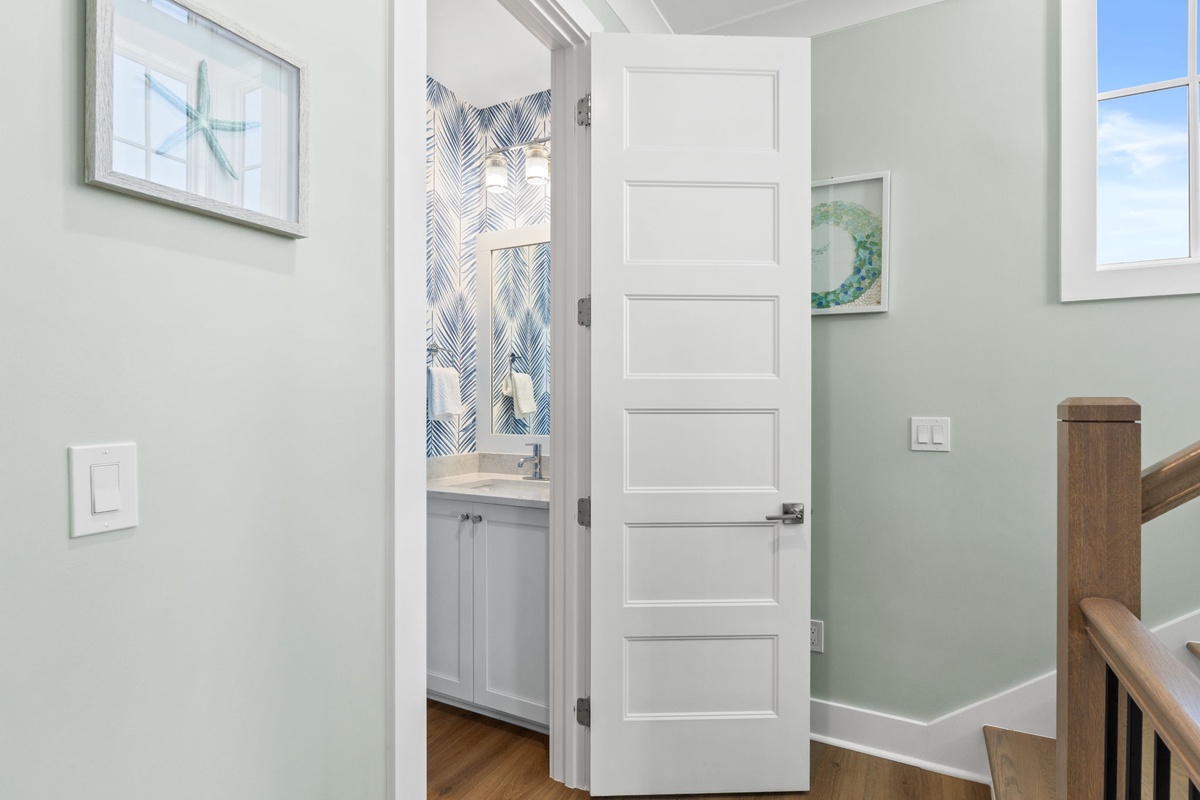 Your private bathroom awaits with soft coastal colors, stylish finishes, and a lovely vanity space—perfect for unwinding after a day of adventure.