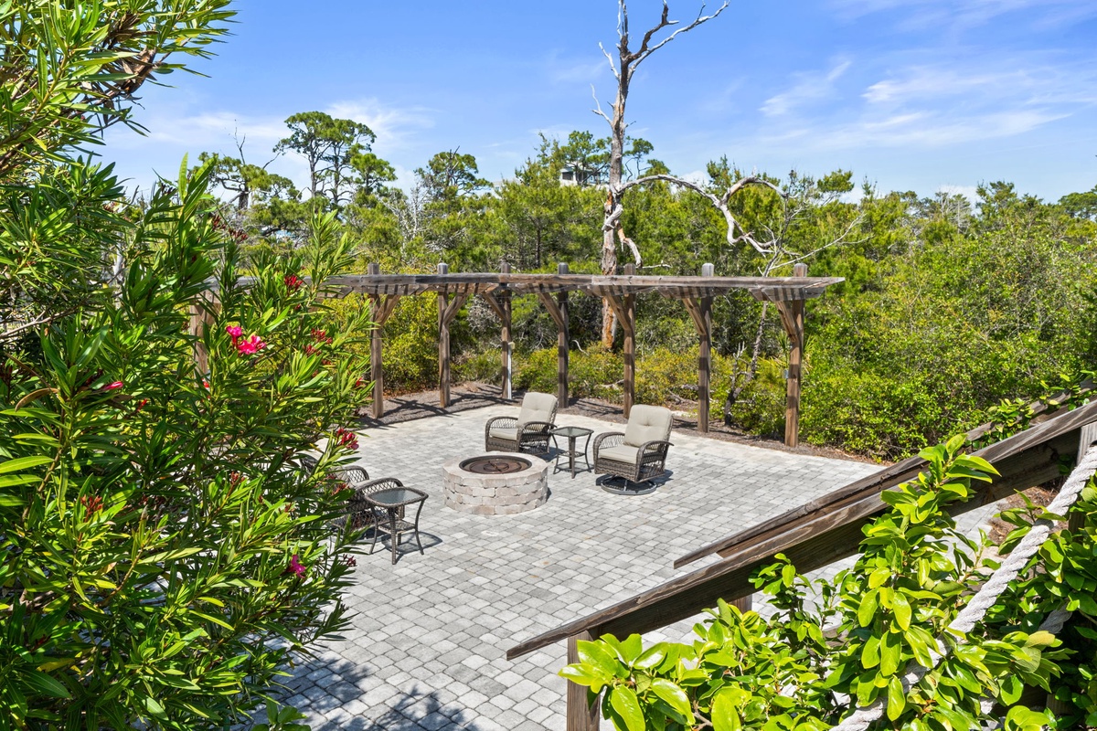 Gather around your private fire pit on this stunning paved patio, surrounded by lush tropical gardens and shaded by a rustic pergola.