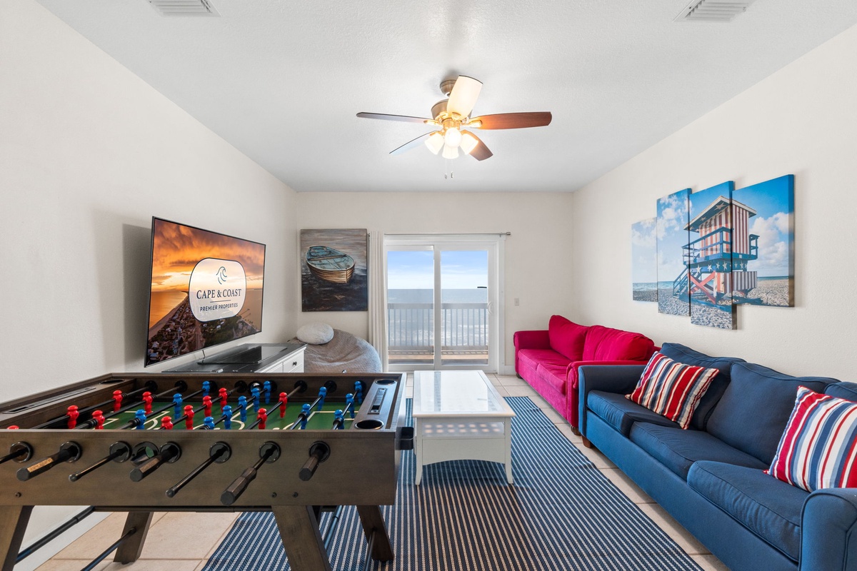 Kick back in your bright living space with vibrant seating, a foosball table for friendly competition, and sliding doors opening to oceanfront views.