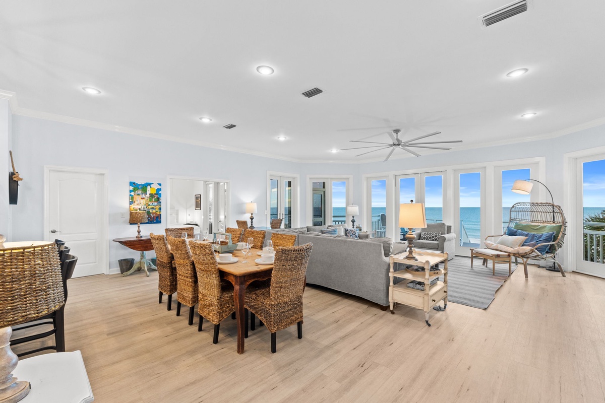 Wake up to stunning ocean views from your spacious living area, where coastal breezes flow through floor-to-ceiling windows into this elegant dining space.