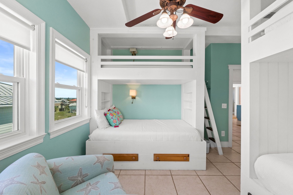 Bright coastal bedroom featuring custom bunk beds with storage drawers, plenty of natural light, and charming beach-themed accents. Your perfect retreat awaits after a day of adventure.