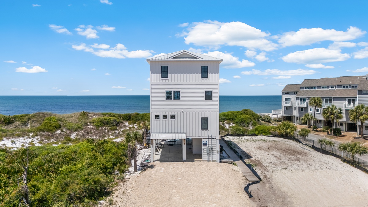 Stunning beachfront property featuring modern coastal architecture with panoramic ocean views and private beach access.