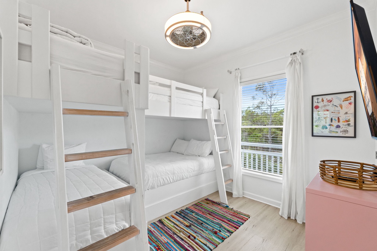 Cozy bunk room where kids can drift off to sweet dreams under the warm glow of stylish lighting.