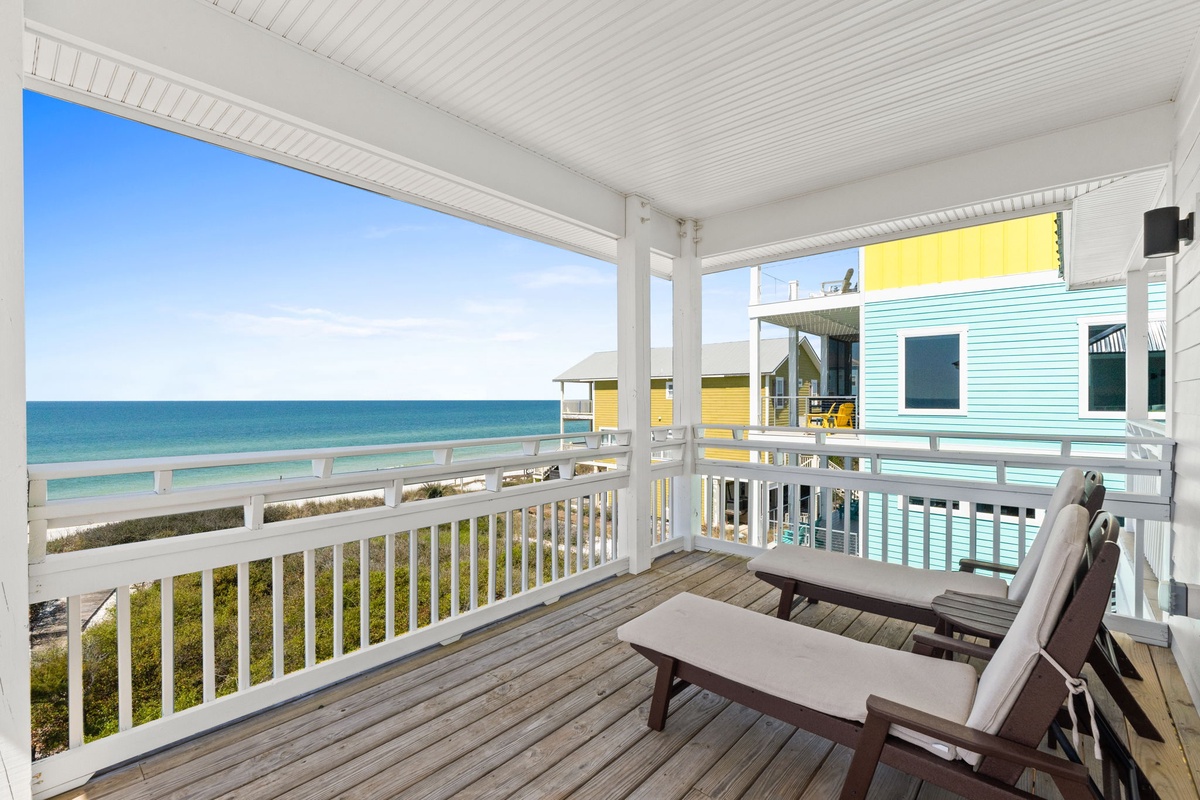 Unwind on your private covered deck with stunning ocean views and comfortable lounge chairs—your perfect spot for morning coffee and sunset cocktails.