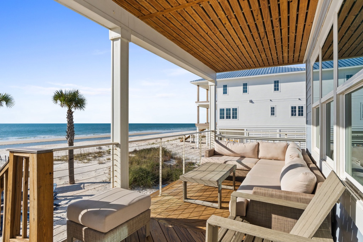 Relax on your private oceanfront deck with stunning sea views and comfortable outdoor seating.