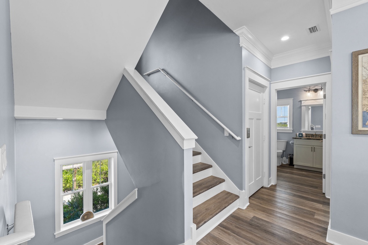 Step into your bright, modern home featuring elegant hardwood floors and a striking staircase that leads to your private upstairs retreat.