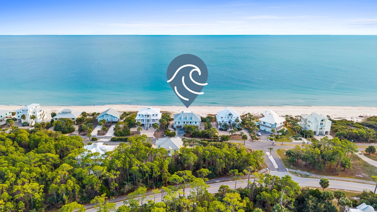 Beachfront vacation rental community with pristine turquoise waters and white sand beach just steps from the property.