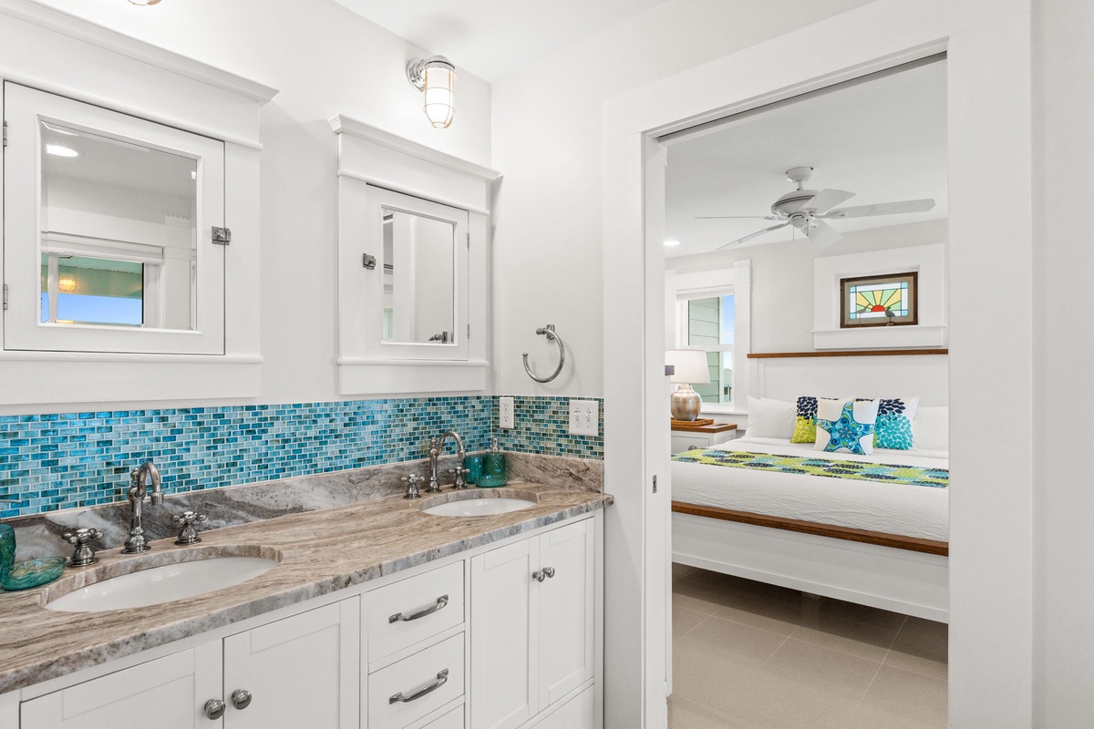 Refresh in your elegant bathroom with stunning turquoise mosaic tiles and marble countertops, then unwind in your bright, airy bedroom.