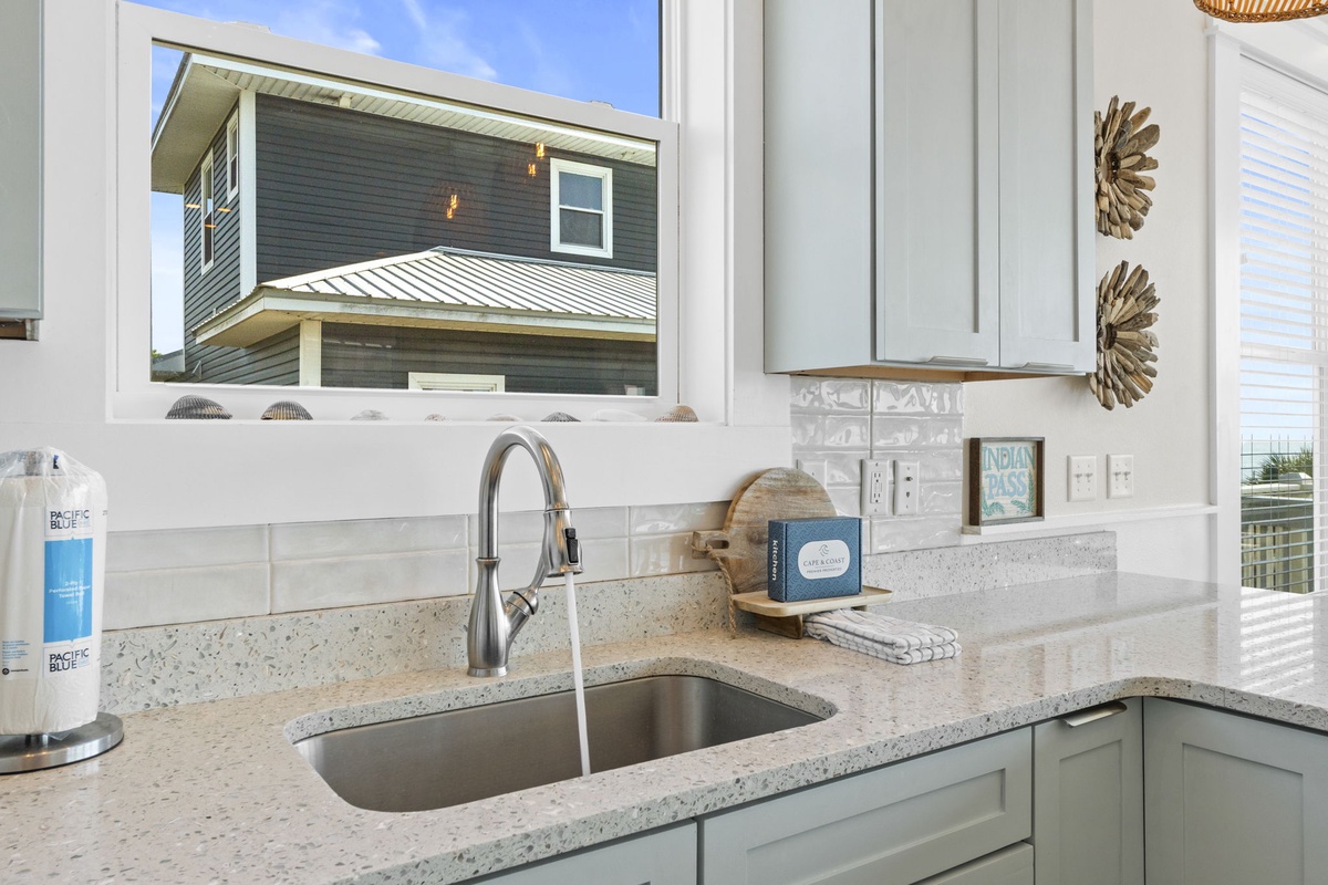 Prepare fresh meals in your well-equipped kitchen with granite counters, modern appliances, and bright natural light streaming through windows.