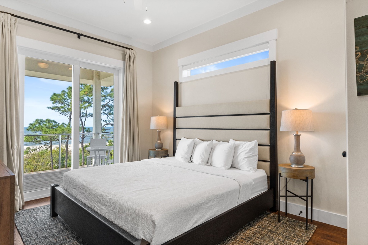 Wake up to natural light streaming through your private balcony doors, with crisp linens and peaceful treetop views welcoming each morning.