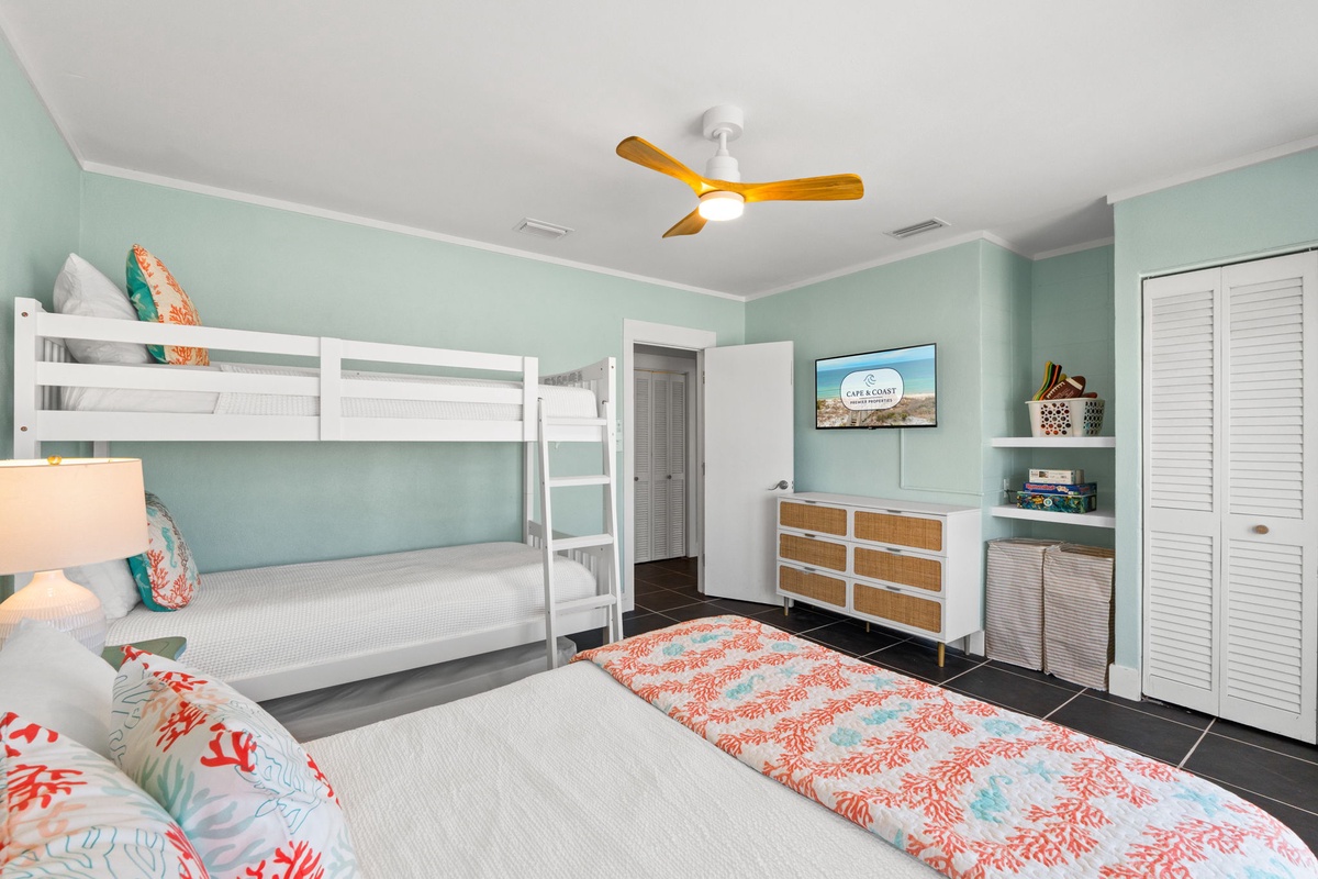 Your coastal retreat features fresh aqua walls, a bunk bed for extra guests, and beach-inspired décor that invites relaxation after sunny days by the shore.