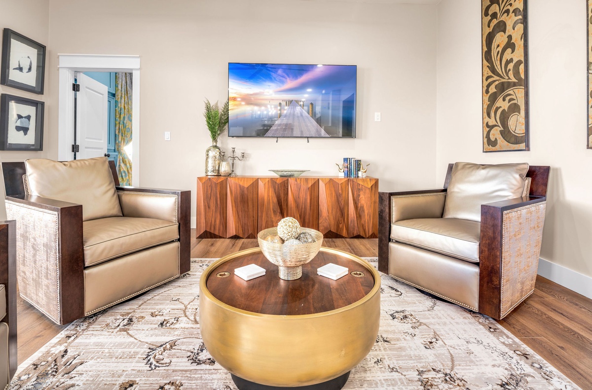 Sink into luxurious leather chairs where you can unwind while watching your favorite shows on the large wall-mounted TV.