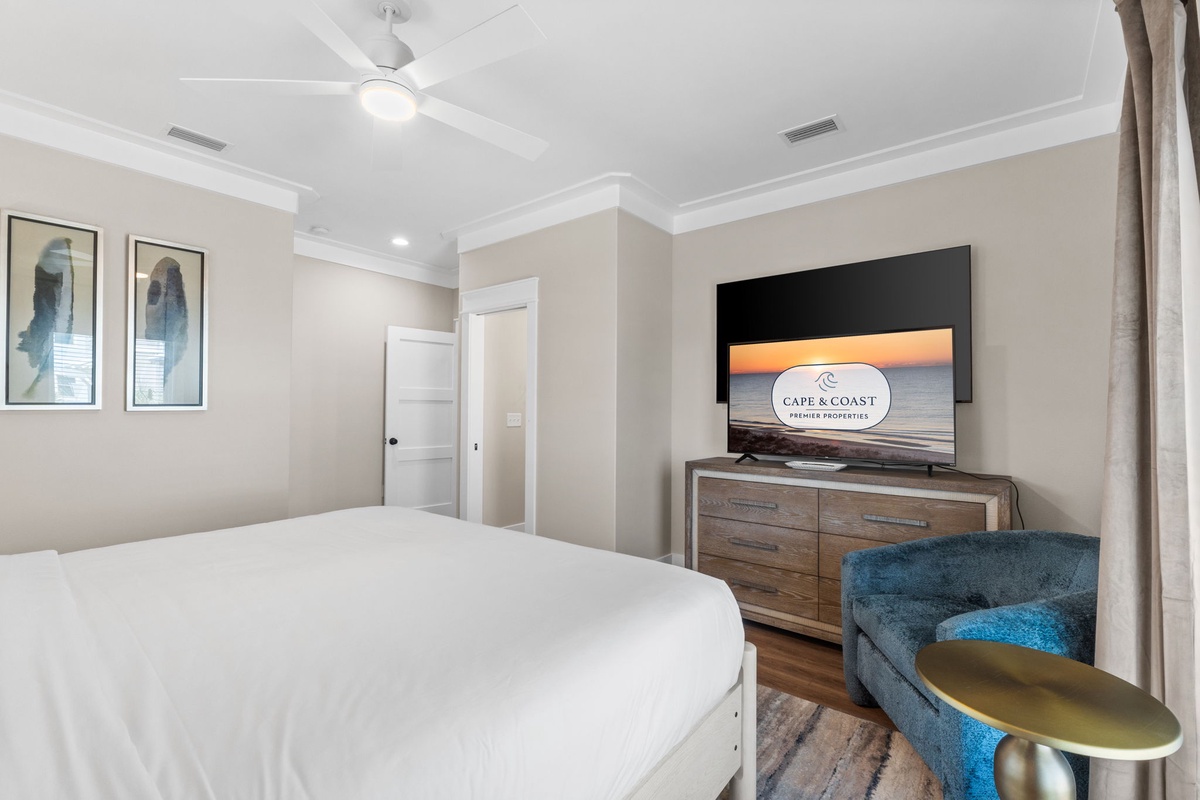 Sink into crisp linens and unwind in your serene bedroom retreat, complete with calming coastal art, a ceiling fan, and a flat-screen TV for your favorite shows.