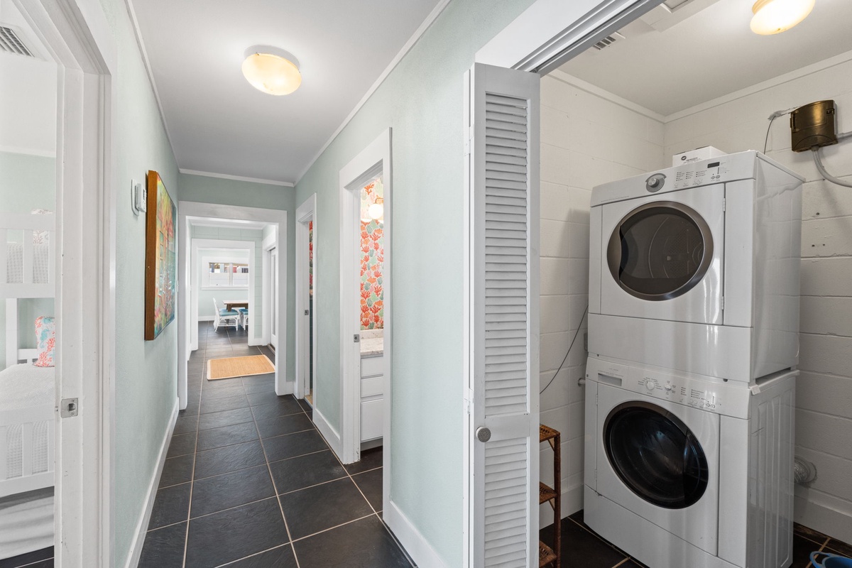 Keep your wardrobe fresh with ease using the stacked washer and dryer tucked neatly behind a louvered door, making laundry day a breeze during your stay.