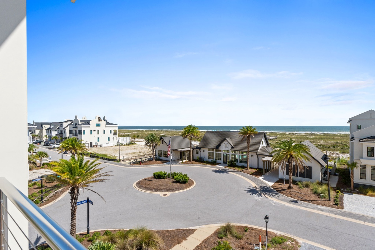 A coastal community with palm-lined streets and beach access visible beyond the residential buildings.