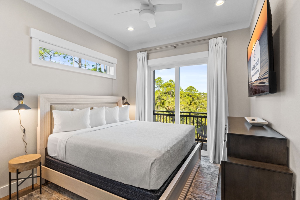 Rest peacefully in your serene bedroom with crisp linens, modern amenities, and tranquil treetop views from your private balcony.