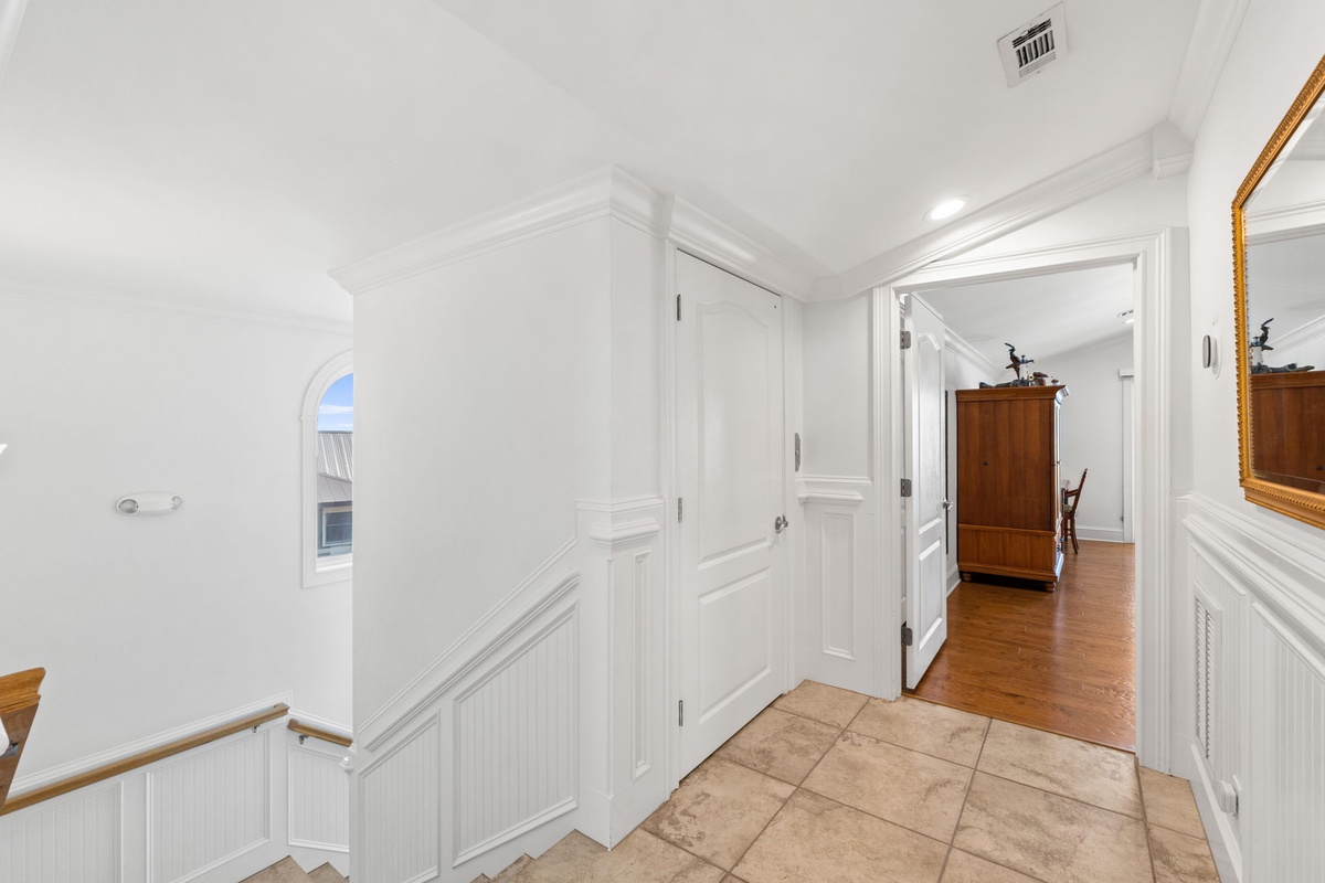 A bright hallway connects thoughtfully designed spaces, with elegant wainscoting and storage built right in for your convenience and comfort.