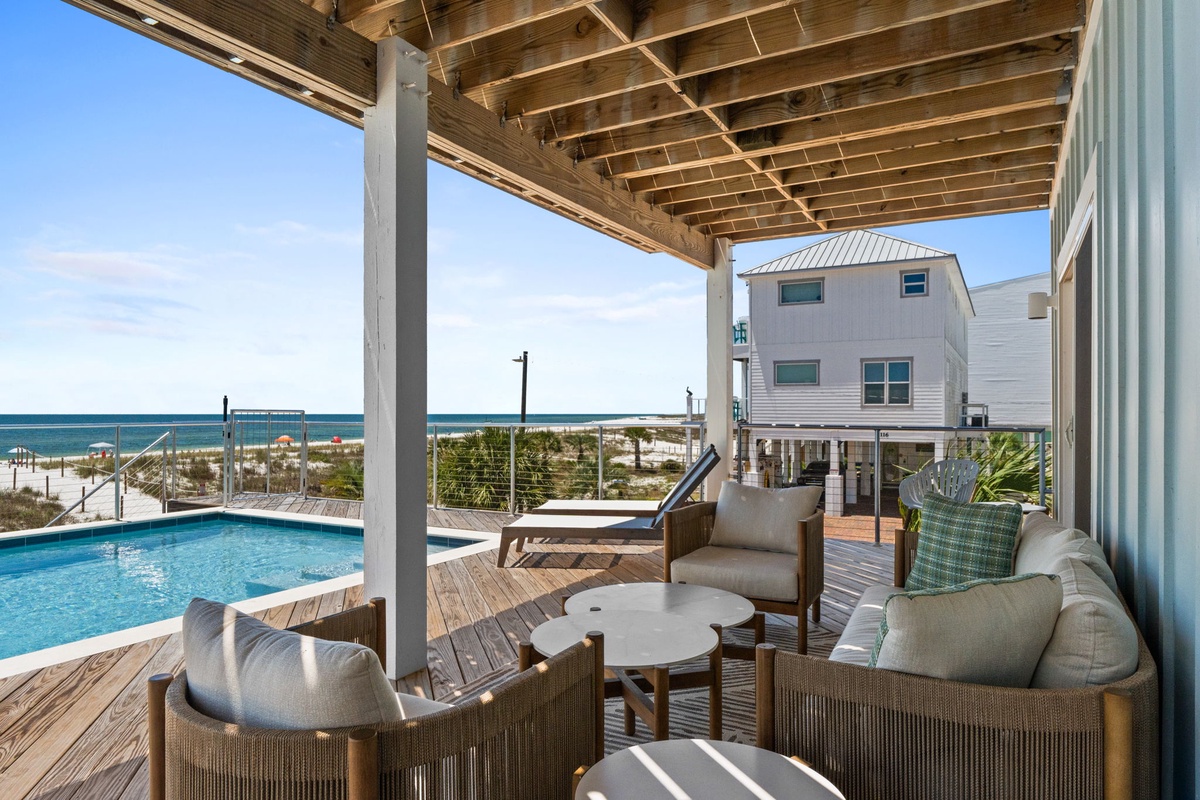Unwind on your private deck with direct beach access, watching the waves roll in from plush outdoor seating. The pool sparkles beside you, perfect for sun-soaked afternoons in paradise.