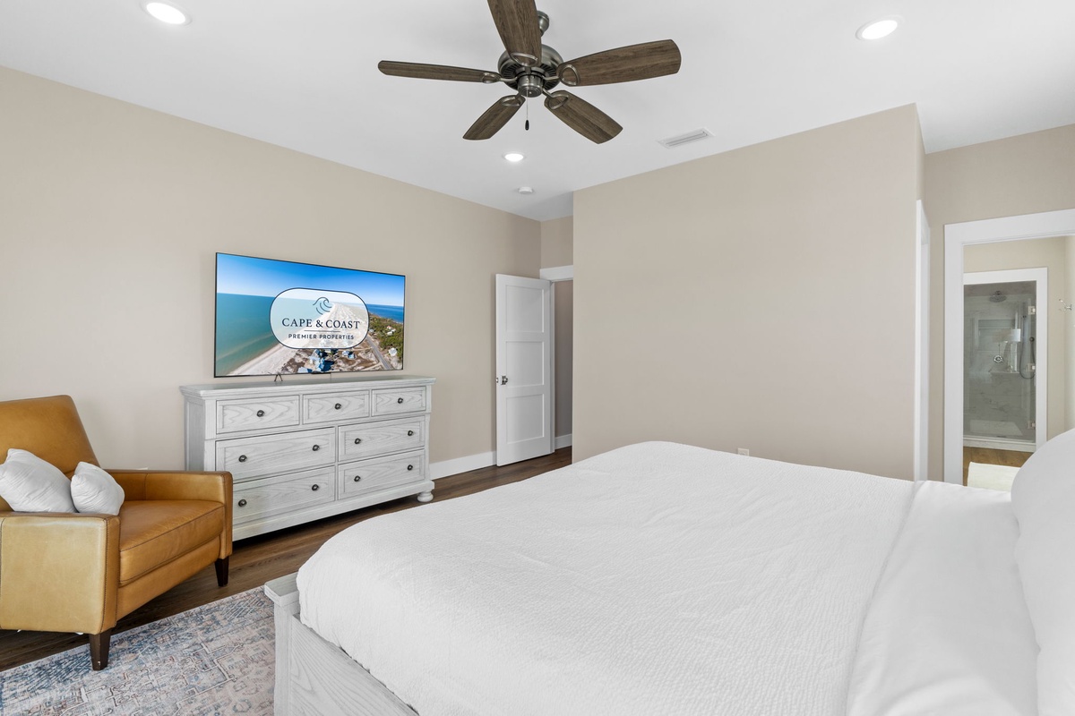 Your spacious bedroom features a king bed, smart TV, ceiling fan, and cozy seating area for ultimate relaxation.