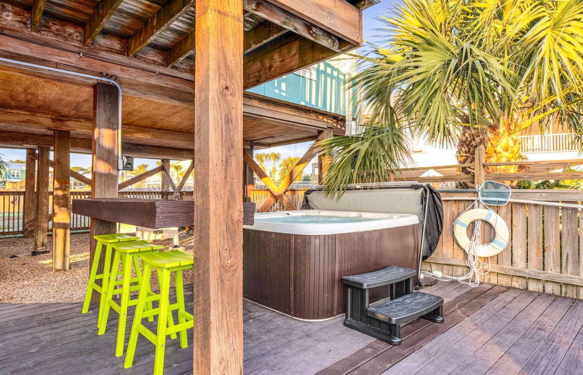 Slip into your private hot tub surrounded by tropical palms and warm wood tones—your perfect sunset sanctuary awaits.