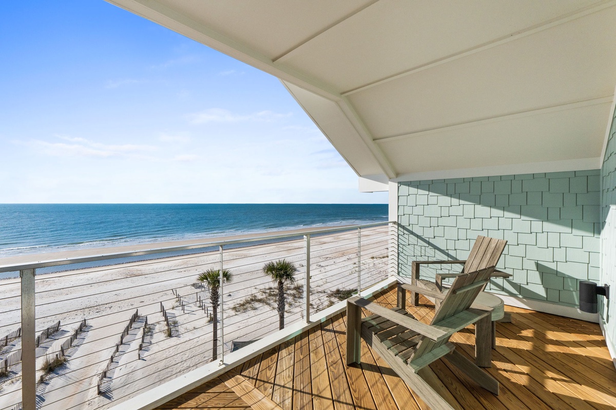 Unwind on your private deck with stunning ocean views and comfortable seating—your perfect beachfront escape awaits.