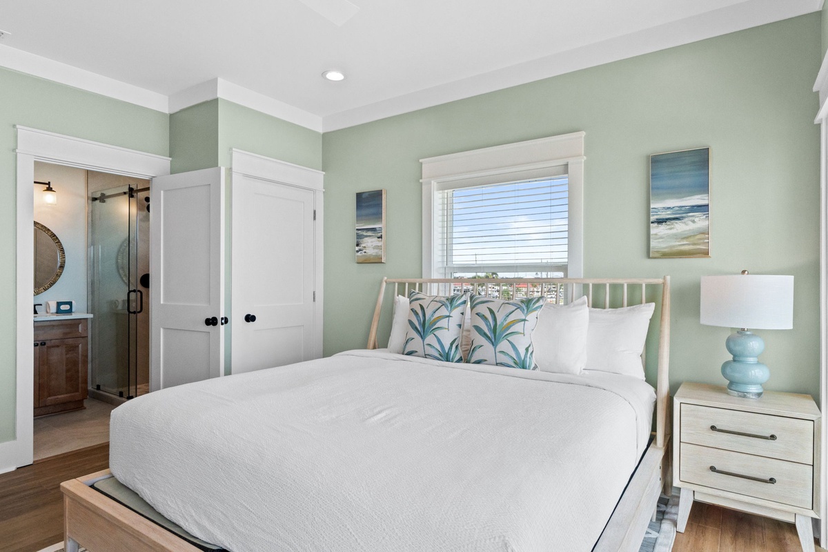 Picture yourself unwinding in this tranquil bedroom, where soft coastal hues and crisp linens invite restful sleep. Your private ensuite awaits, completing this peaceful retreat.