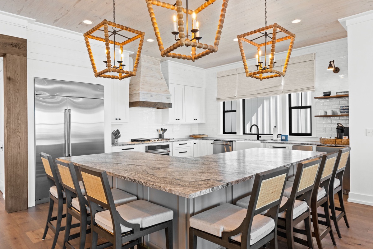 Your gourmet kitchen awaits with spacious granite island, premium appliances, and stunning rope chandeliers for memorable meals together.