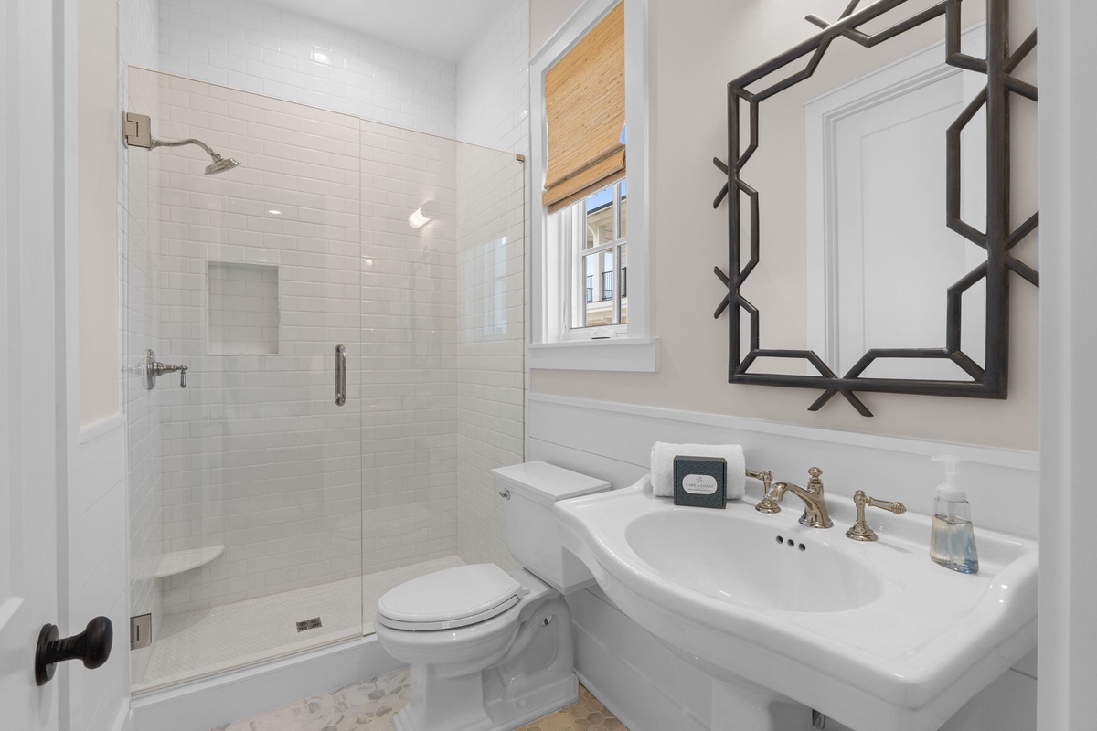 Step into your bright, modern bathroom with its walk-in shower, elegant fixtures, and classic white subway tiles—everything you need to feel refreshed and ready for your day.