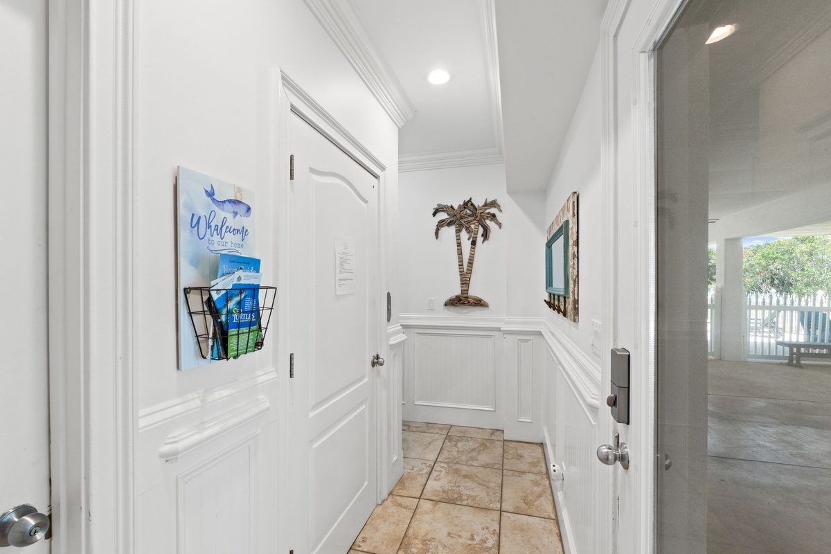 Step inside and immediately feel the coastal charm—crisp white wainscoting, breezy décor, and warm tile floors set the tone for your beach retreat.