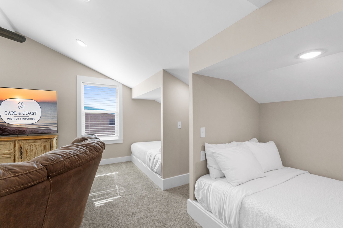 Cozy sleeping nook with built-in beds and entertainment area where you can unwind after beach adventures.