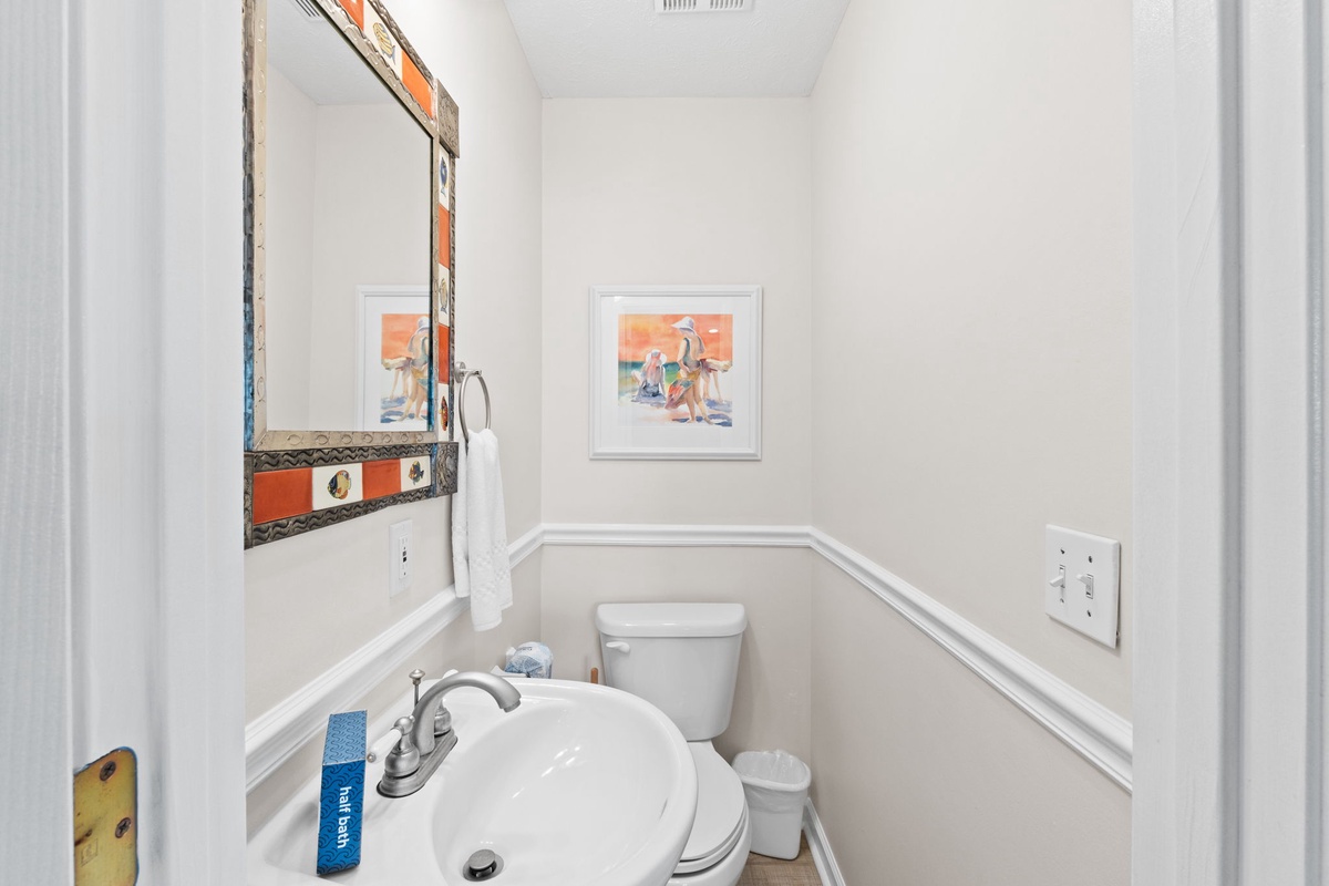 Your private powder room features cheerful artwork and thoughtful touches, making every moment feel welcoming and comfortable.