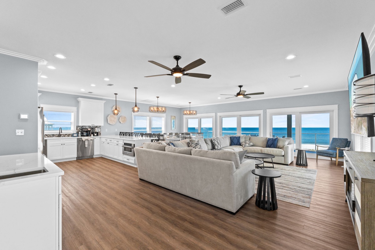 Step into your coastal retreat where the ocean becomes your living room backdrop. Relax on plush sofas as sunlight streams through floor-to-ceiling windows, revealing endless blue horizons. The open layout invites you to cook, dine, and unwind while savor