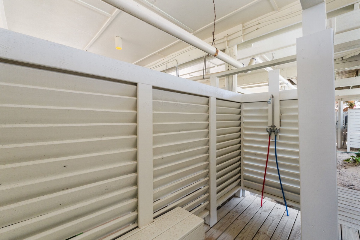 Your covered outdoor shower awaits, with louvered walls for privacy and easy access to rinse off after a day of adventure.