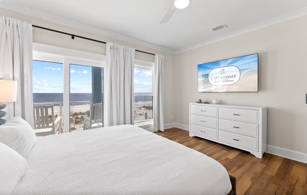 Wake up to stunning ocean views from your serene bedroom, where soft linens and peaceful coastal vibes set the tone for perfect beach mornings.