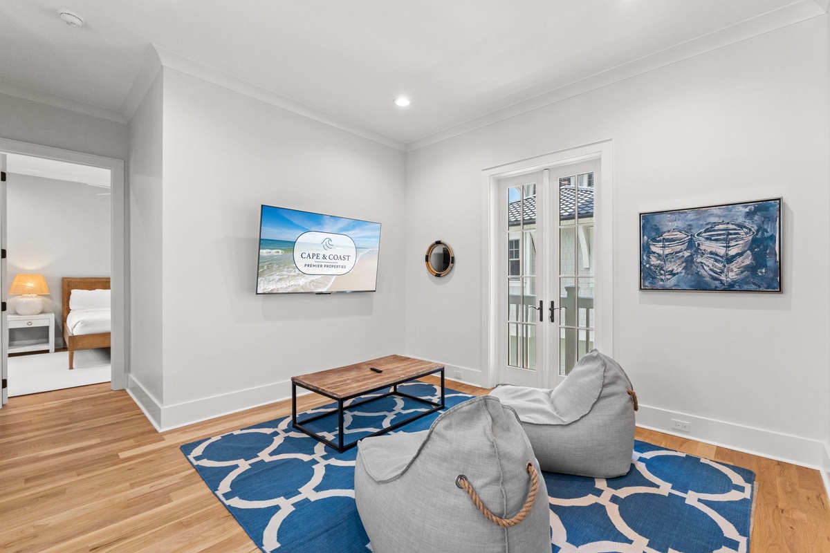 Settle into this bright, coastal-inspired living space where nautical artwork and a bold blue rug bring beachy vibes indoors. Perfect for unwinding after a day of adventure.