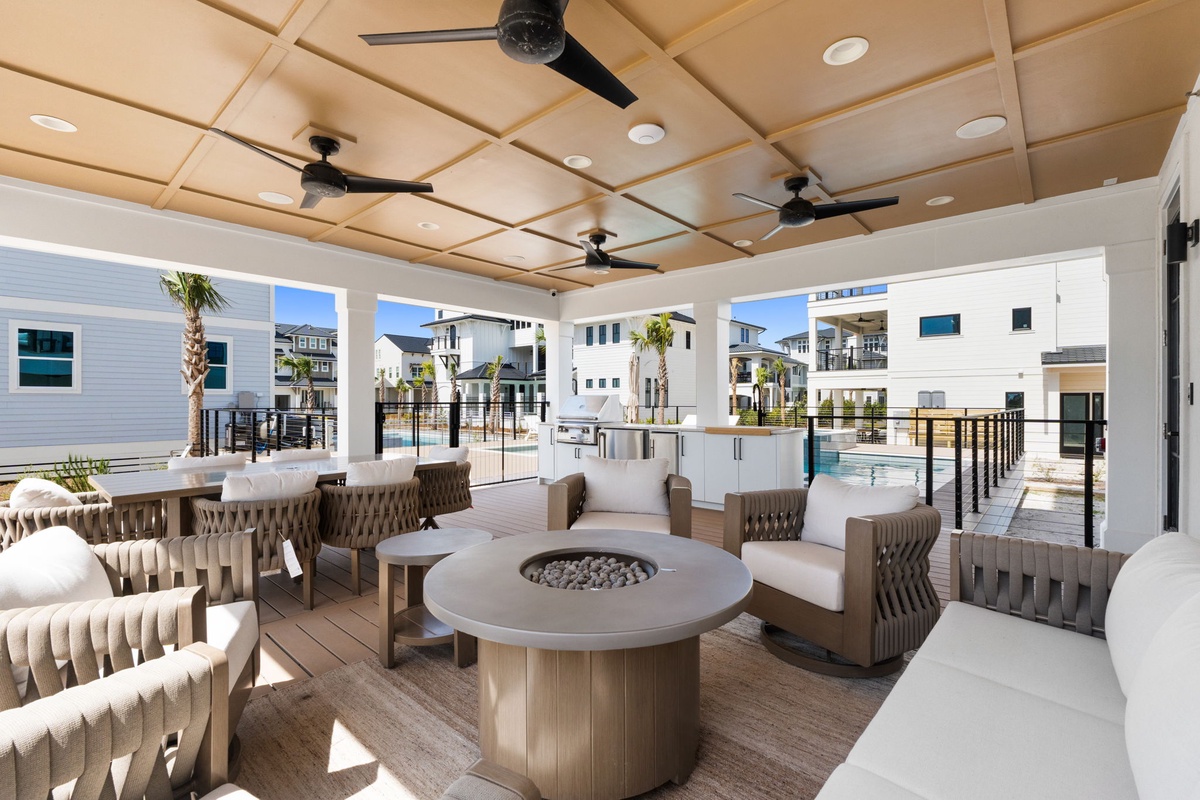 Unwind in your covered outdoor lounge with a cozy fire pit, ceiling fans, and stunning pool views.