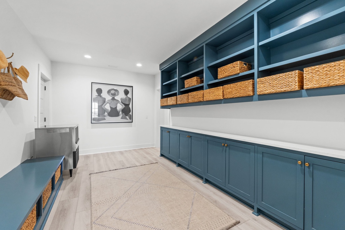 Your personal organization haven features stylish blue cabinetry and woven baskets, creating a serene space for all your belongings.