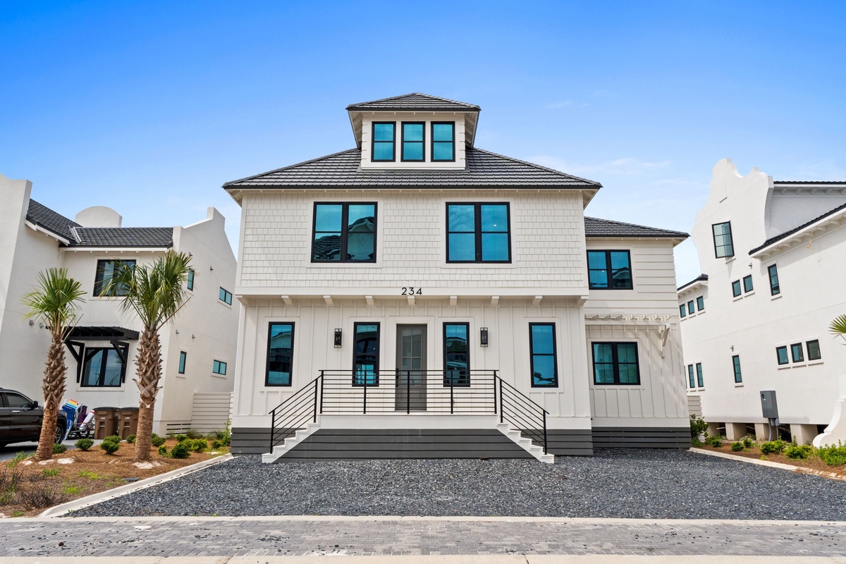 Modern coastal residence with elegant architectural details, located in a quiet neighborhood setting with convenient off-street parking and easy access.