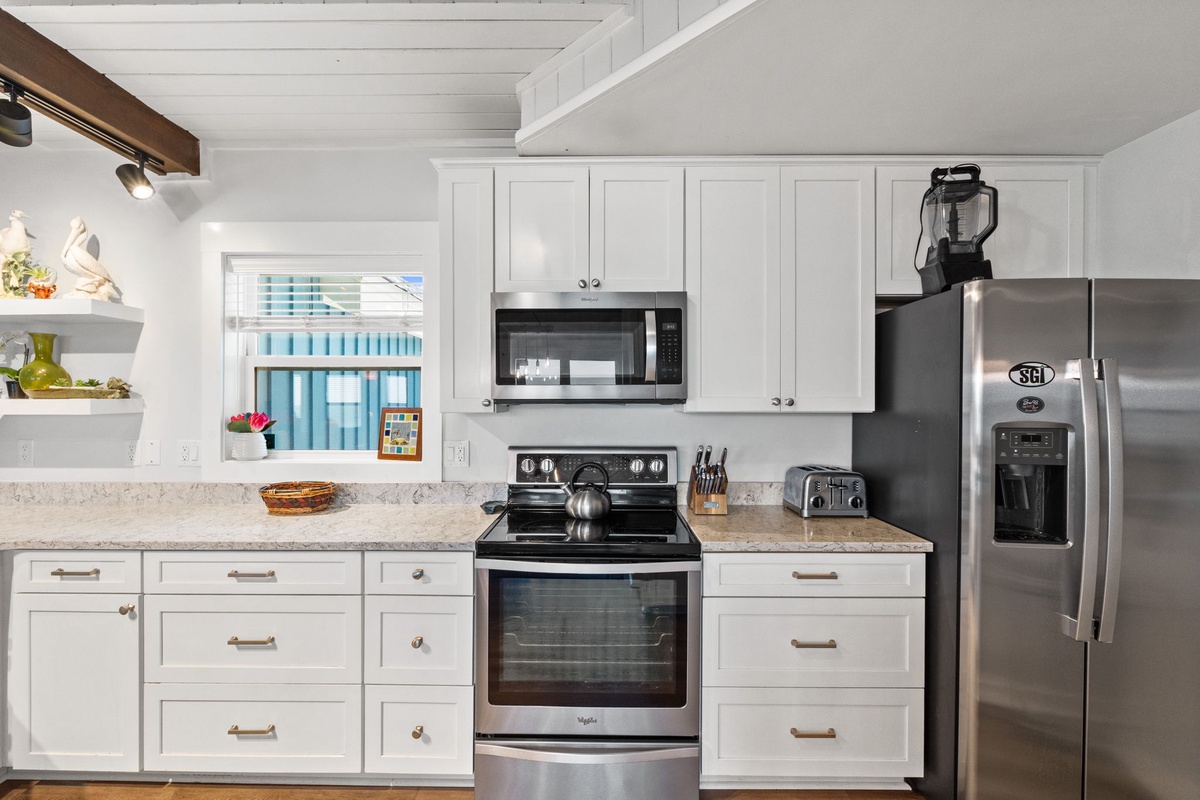 Your bright, fully equipped kitchen makes meal prep a breeze with modern stainless steel appliances, granite counters, and plenty of cabinet space to feel right at home.