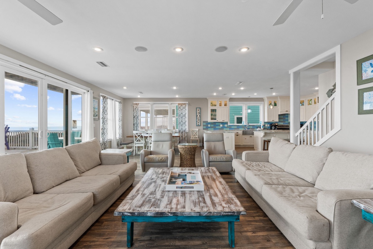 Relax in your spacious living room with panoramic ocean views and coastal decor that perfectly frames your beach getaway.