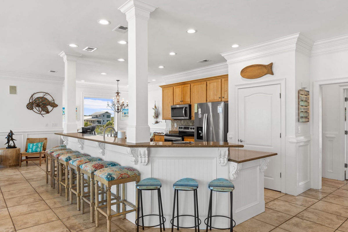 Gather at this welcoming kitchen, where you'll find a spacious island with seating for everyone, granite countertops, and modern appliances ready for your culinary adventures.