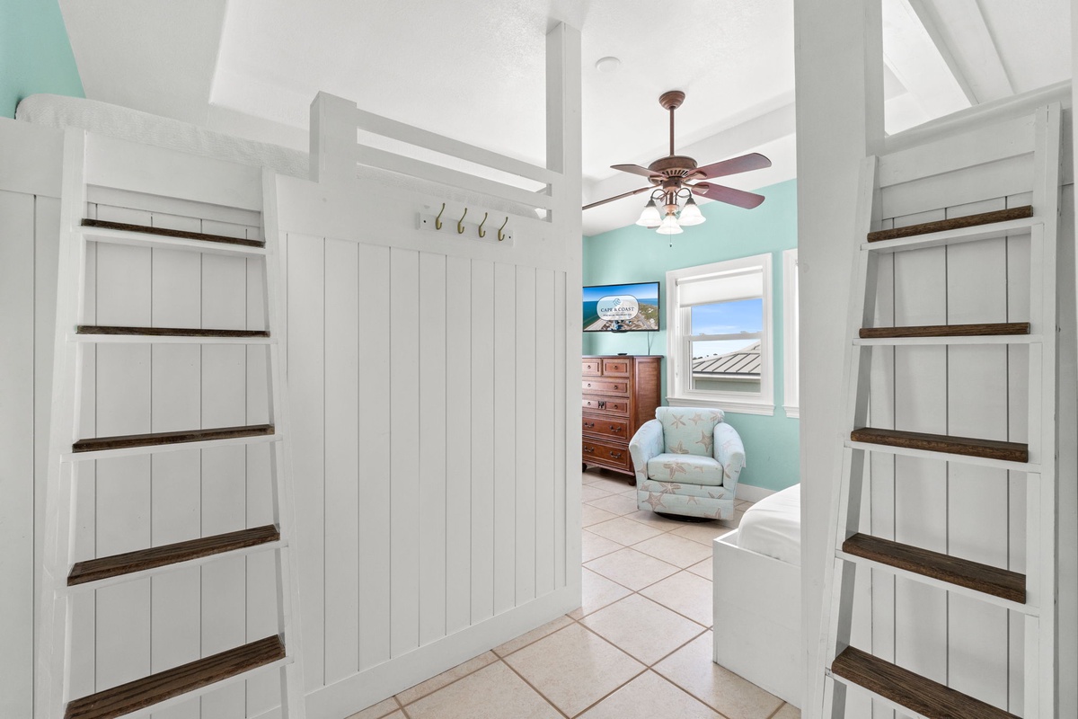 Step into your coastal retreat where open shelving and breezy turquoise walls create an inviting, beach-inspired atmosphere that instantly helps you unwind.