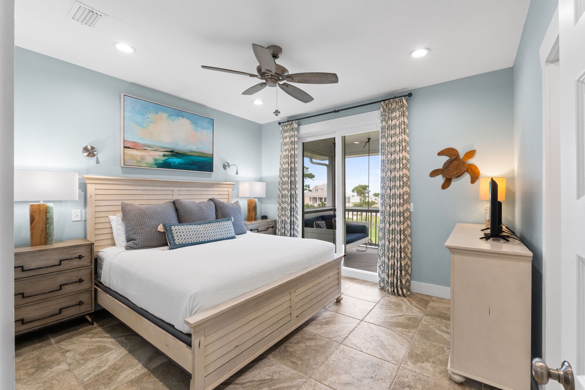 Your serene coastal retreat features soothing ocean hues, coastal artwork, and private balcony access. Sink into crisp linens beneath gentle ceiling fan breezes while ocean views beckon through your doorway.
