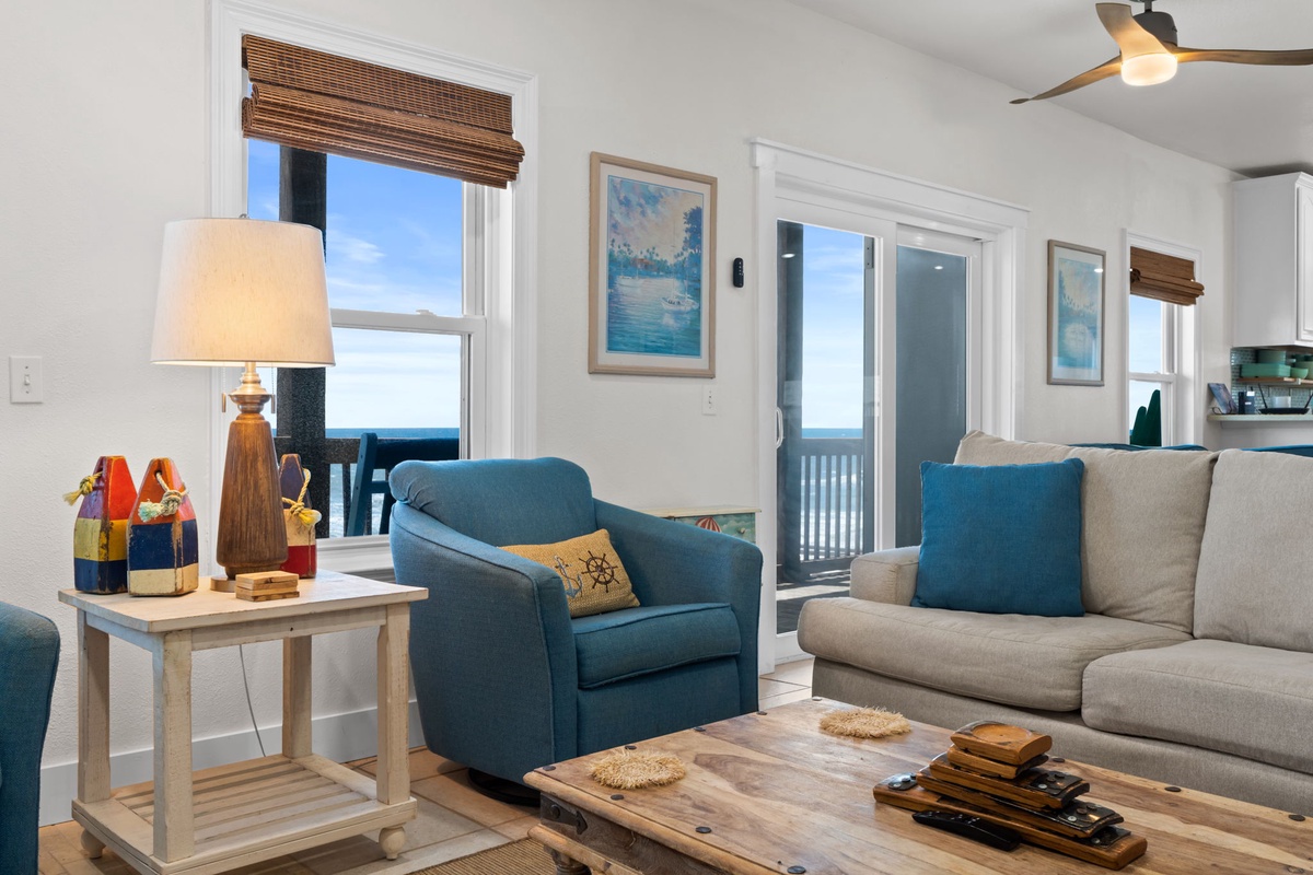 Settle into your coastal retreat with ocean views from every window. Soft furnishings, beach-inspired decor, and gentle ceiling fans create a breezy, welcoming atmosphere perfect for your seaside escape.
