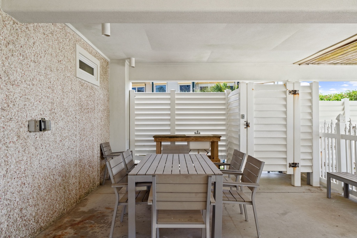 Your covered outdoor dining area awaits with stylish seating for meals and entertaining, complete with privacy screens, coastal textures, and a peaceful, sheltered atmosphere for relaxing together.