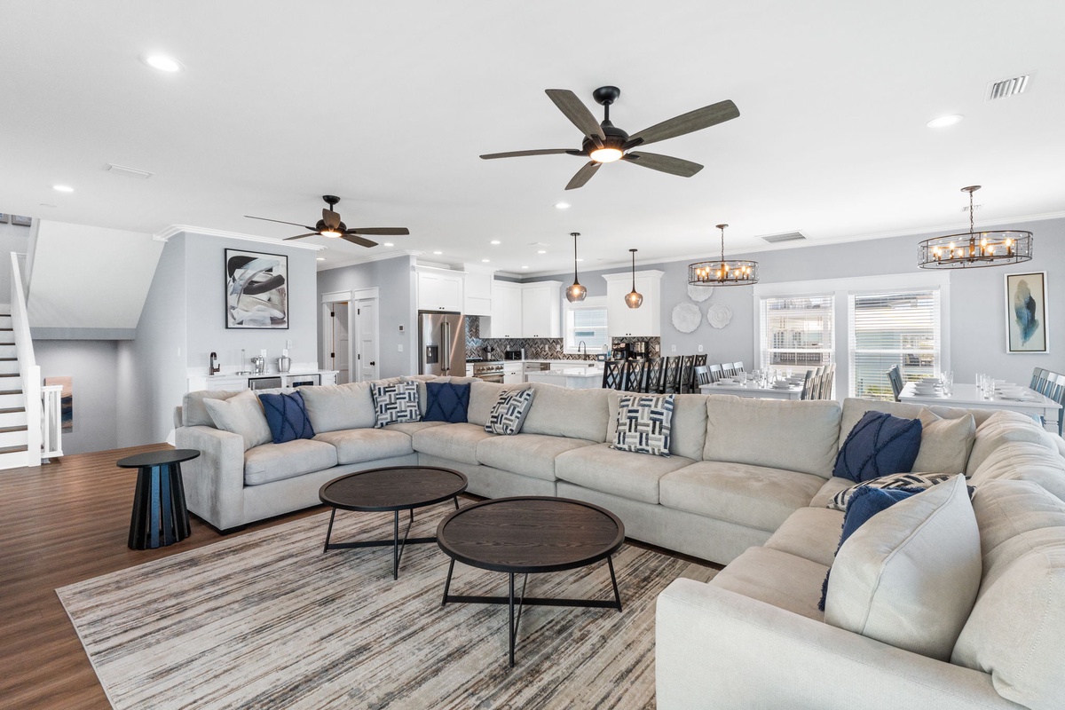 Sink into plush seating with room for everyone, where coastal blues and natural light create your perfect gathering space for relaxation and connection.