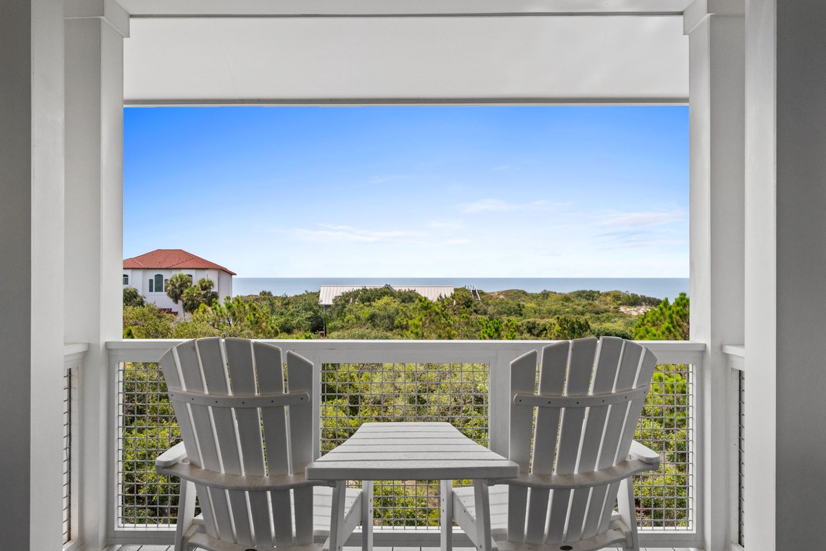 Settle into your private balcony with sweeping ocean views beyond lush coastal greenery—perfect for savoring morning coffee or watching the sky change colors.