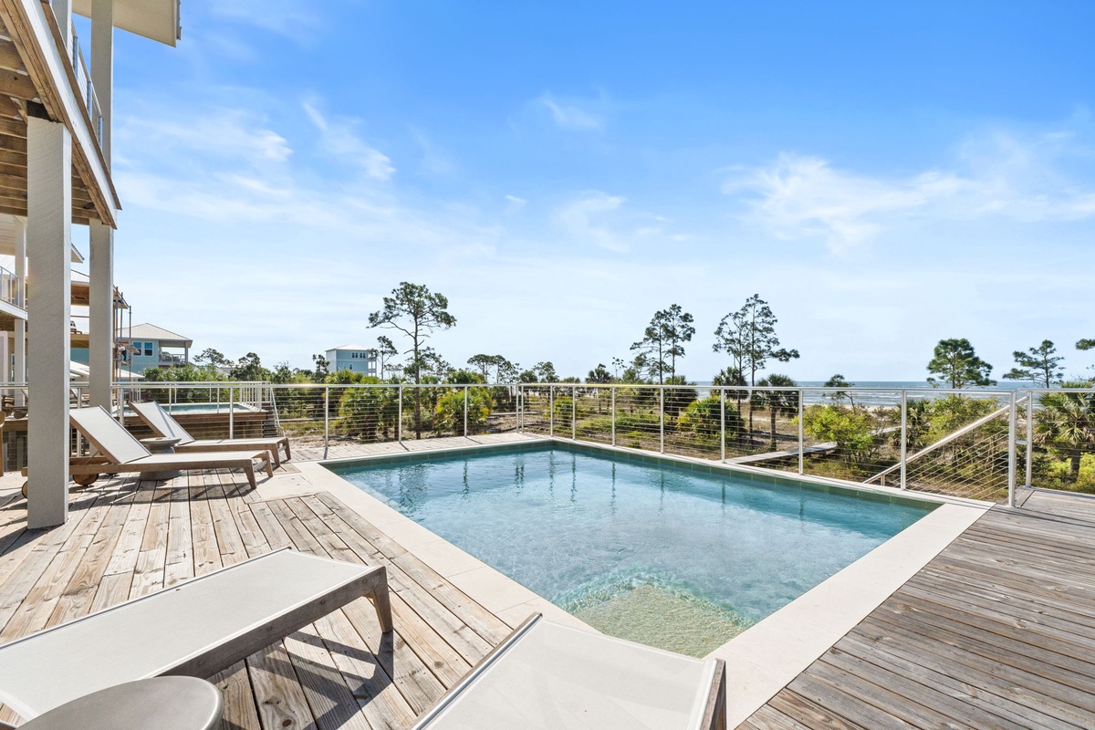 Soak up sunshine on your private pool deck, where crystal waters meet coastal views through sleek railings.