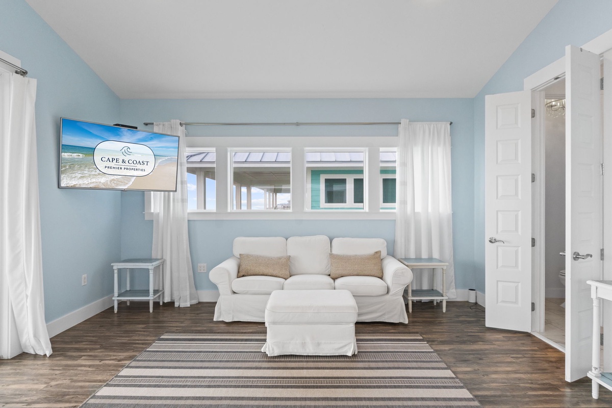 Sink into soft coastal comfort in your bright living space, where ocean breezes flow through and peaceful blues create the perfect seaside retreat.
